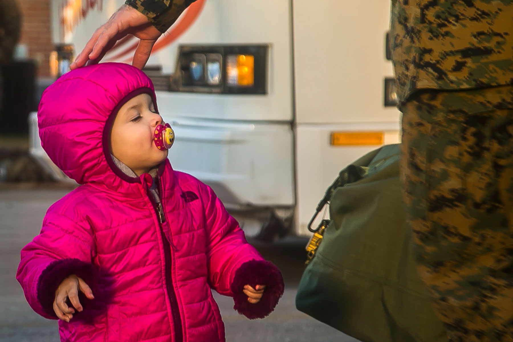 A child interacts with a U.S. Marine with the 26th Marine Expeditionary Unit (MEU), during the unit's departure from Camp Lejeune, N.C., to embark on a deployment at sea Feb. 6, 2018.  (U.S. Marine Corps)
