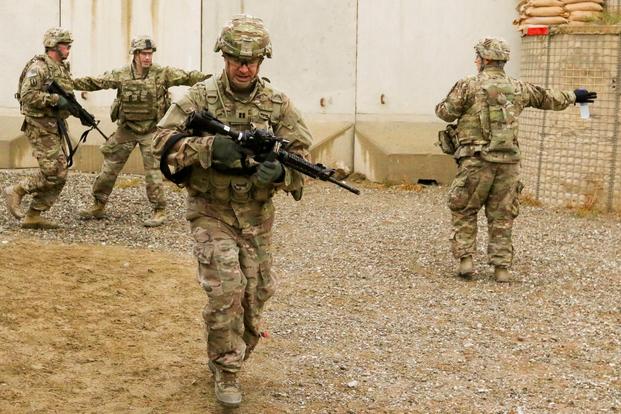 Soldiers run to their firing positions during a marksmanship competition as part of the celebration of Marne Week Forward at Bagram Airfield, Afghanistan, Nov. 16, 2017. (Photo by Ellen Lovett/U.S. Forces Afghanistan)