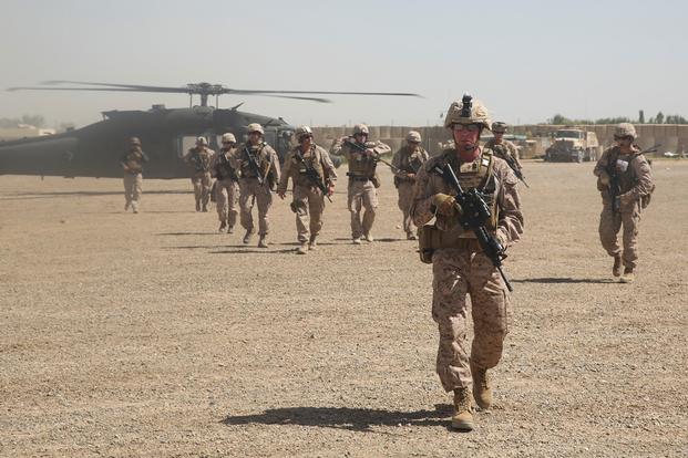 U.S. Marines with Task Force Southwest depart a UH-60 Blackhawk helicopter prior to an advisory meeting with Afghan National Army soldiers at Camp Hanson, Afghanistan, June 13, 2017. (U.S. Marine Corps photo) 