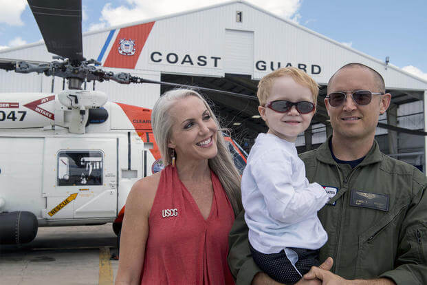 The 2017 Armed Forces Insurance Coast Guard Spouse of the Year, Mary Nelson, poses for a photo with her son Wyatt, 4, and husband, Petty Officer 1st Class James Nelson at Air Station Clearwater, Florida. (U.S. Coast Guard/Michael De Nyse)