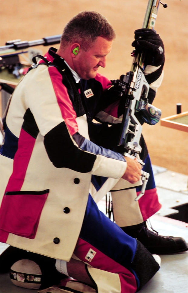 Capt. Glenn A. Dubis prepares to shoot from the kneeling position during qualifications for the Men's 50 meter rifle three position at the 2000 Olympic Games in Sydney.