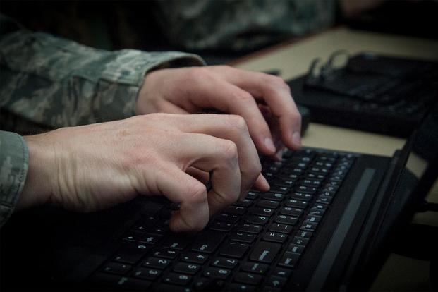 An airman types on his computer at MacDill Air Force Base, Fla.