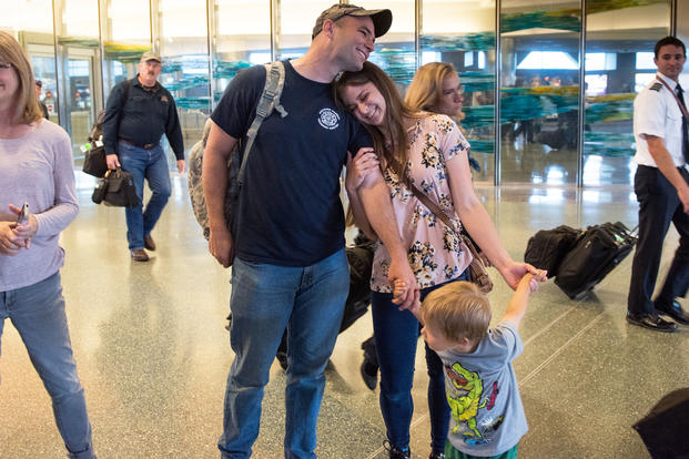 Spc. Joshua Monroe is greeted by his wife, son and friends and senior Idaho Army National Guard leadership, in Boise, Idaho. (Idaho National Guard/Robert Barney)