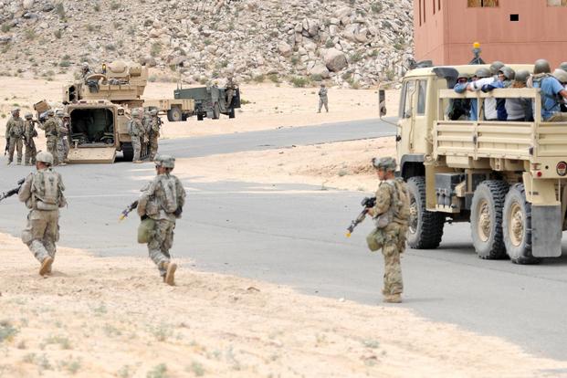 Dismounted Soldiers of Company B, 1st Battalion, 155th Infantry Regiment, Mississippi Army Guard provide security for a civilian evacuation exercise at the National Training Center, Fort Irwin, California on May 31, 2017. (Mississippi National Guard/Sgt. Edward Lee, 102d Public Affairs Detachment)