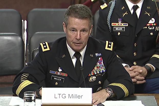 Army Lt. Gen. Austin S. Miller testifies before the Senate Armed Services Committee in Washington during a hearing to review his nomination as the next Resolute Support mission commander and commander of U.S. Forces-Afghanistan, June 19, 2018. His son, Army 2nd Lt. Austin Miller, sits behind him. (Screengrab from DVIDS Video)