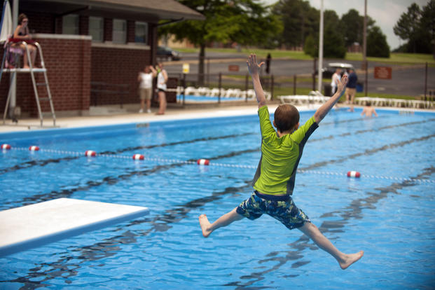 A child jumps into a pool at Little Rock Air Force Base, Arkansas.  (U.S. Air Force/Scott Poe)