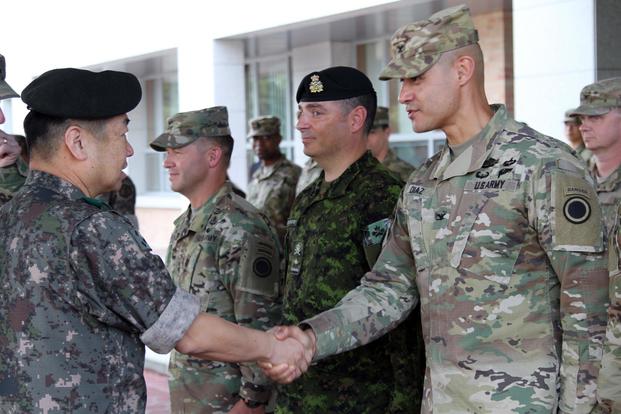 Gen. Woon-Young Kim, Third Republic of Korea commanding general, greets Col. Mario Diaz, I Corps chief of staff during a cermony marking the start of their units involvement in combined, joint training exercise Ulchi Freedom Guardian, August 24, 2017. (U.S. Army/Sgt. Maj. Randy Randolph)