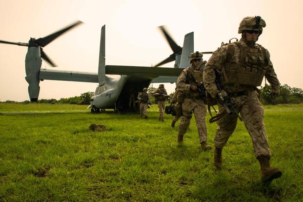 U.S. Marine Lance Cpl. Joshua Ewald, right, a member of Special-Purpose Marine Air-Ground Task Force Crisis Response-Africa, runs off an MV-22B Osprey during a training mission outside Accra, Ghana, April 13, 2015. (U.S. Marine Corps/Sgt. Paul Peterson)