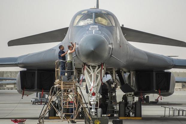 Crew chiefs prepare a B-1B Lancer on Al Udeid Airbase, Qatar, for combat operations against Islamic State of Iraq and the Levant terrorists, April 8, 2015. (U.S. Air Force/Senior Airman James Richardson)