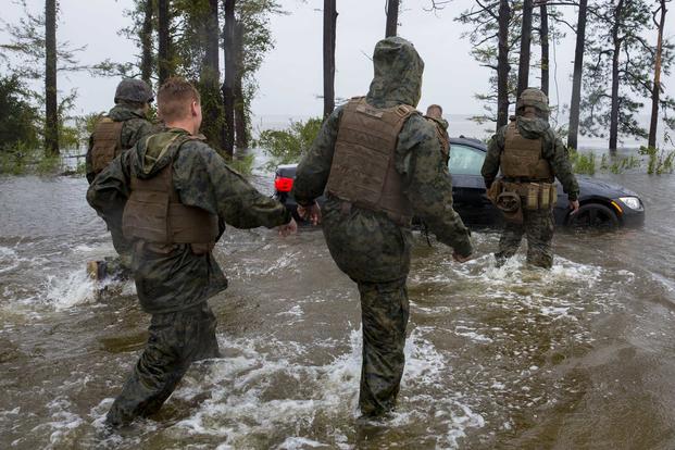 Marines help push a car out of a flooded area at Camp Lejeune, North Carolina, on Sept. 15, 2018, during Hurricane Florence. H(U.S. Marine Corps photo by Lance Cpl. Isaiah Gomez)