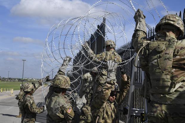 Soldiers from various Engineering Units install concertina wire Nov. 5, 2018, on the Anzalduas International Bridge, Texas. (US Air Force/Airman First Class Daniel A. Hernandez)
