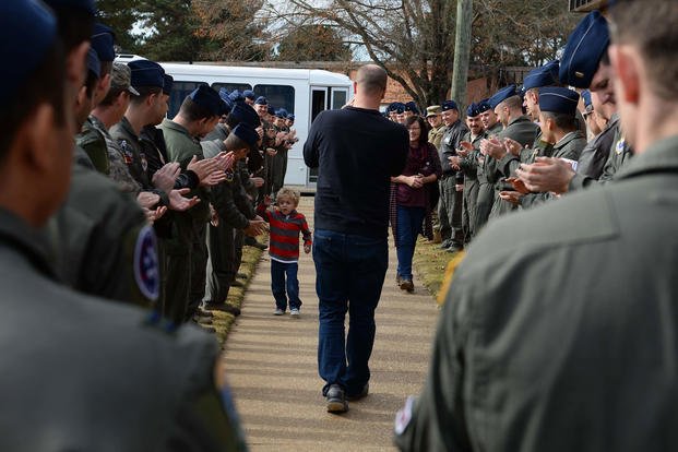 Pilots from the 41st Flying Training Squadron welcome Tobias Taylor, Pilot for a Day, and his family, Dec. 6, 2018, on Columbus Air Force Base, Mississippi. (U.S. Air Force/Hannah Beam)