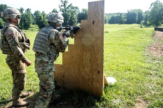 A sergeant from the 4th Infantry Division standing near a cadet as he negotiates the new buddy-team live fire course at ROTC Advanced Camp at Fort Knox, Kentucky. (U.S. Army/Spc. Dana Clarke)