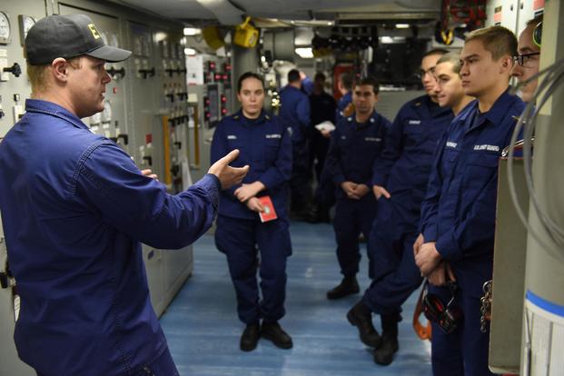 Petty Officer 2nd Class Keith Bryan, a machinery technician in the Coast Guard Cutter Polar Star's main propulsion division, explains simulation procedures before engineering casualty exercises while underway in the Ross Sea, near Antarctica, Feb. 4, 2016. (U.S. Coast Guard/Petty Officer 2nd Class Grant DeVuyst)