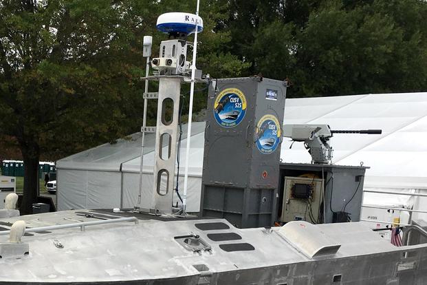 Close-up image of the box-style launcher from the Common Unmanned Surface Vehicle (CUSV) holding two Hellfire Missiles and a .50 caliber machine gun. (Matthew Cox/Military.com)