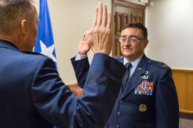 Maj. Gen. Tom Wilcox (left), Air Force Installation and Mission Support Center commander, administers the Oath of Office to Col. Martin Pantaze (right), during a promotion ceremony at Barksdale Air Force Base, Louisiana, September 4, 2019. (U.S. Air Force/Senior Airman Tessa B. Corrick)