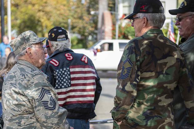 Two veterans talk with each other during the Yuba-Sutter Veterans Day Parade in Marysville, California,