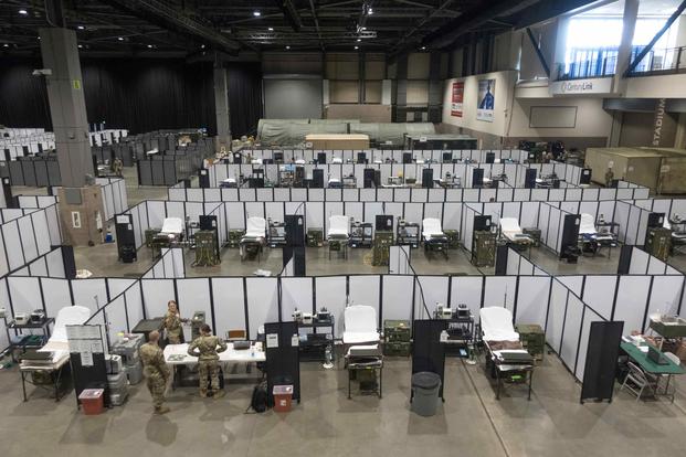 Soldiers work to set up a field hospital in the Centurylink Field Events Center in Seattle.