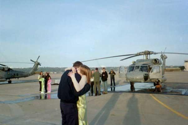 couple embracing in front of airplane