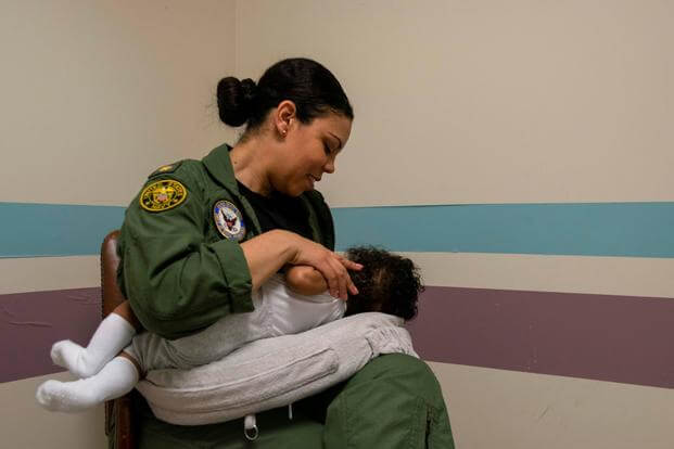 A sailor breastfeeds her child in the lactation room at Naval Support Facility Arlington.