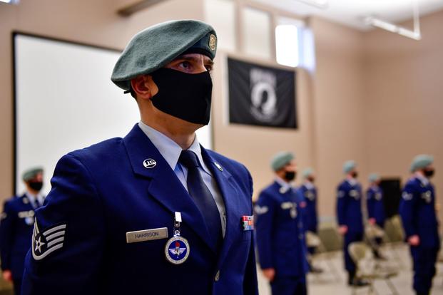An airman stands in formation during a SERE Specialist Apprentice Course graduation ceremony.