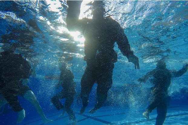 Aspiring Marine Corps Martial Arts Program instructors conduct aquatic workouts.