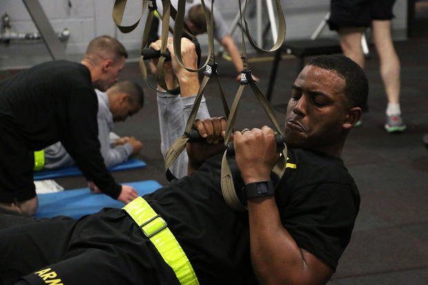 An Army captain goes through a suspension training workout.