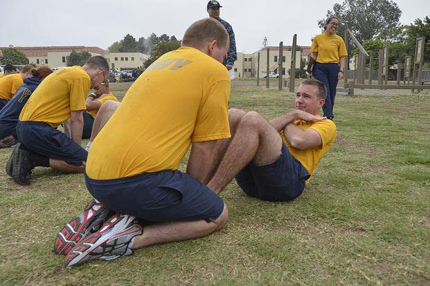 A sailor performs the curl-up portion of the Navy’s physical readiness test (PRT).