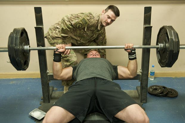 A Department of Defense civilian performs a bench press at Bagram Air Field, Afghanistan.