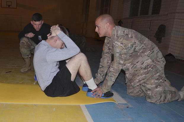 A soldier conducts sit-ups during an Army physical fitness test.