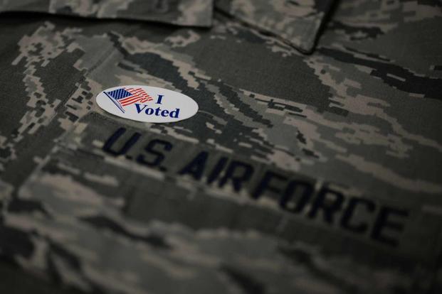 Airman sports an “I Voted” sticker after going to the polls.