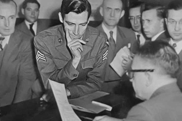 Sgt. Martin J. Monti listening to a federal judge after being arrested in 1947.