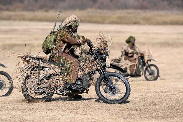 Members of the Japan Ground Self Defense Force ride motorcycles.
