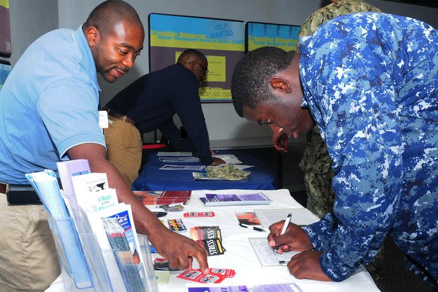 A sailor signs up for health benefits during a transition assistance program class at Norfolk Naval Station, Virginia. 
