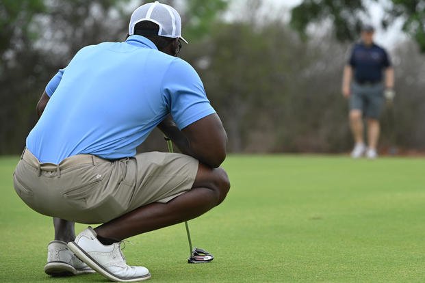 Retired Chief Master Sgt. Brian Lewis, former 47th Operations Group chief, observes the course at the Golf Trick Shot Event at Laughlin Air Force Base, Texas.