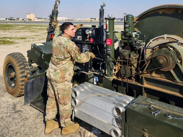 A U.S. Air Force senior airman operates a rewind system as it brings new aircraft arresting tape from the runway to the hydraulic braking system at Ali Al Salem Air Base, Kuwait.
