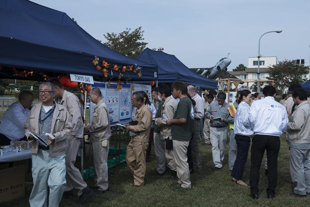 Attendees of Naval Air Facility (NAF) Atsugi’s annual energy fair gather around the Tokyo Gas tent during an event at Taylor Field.