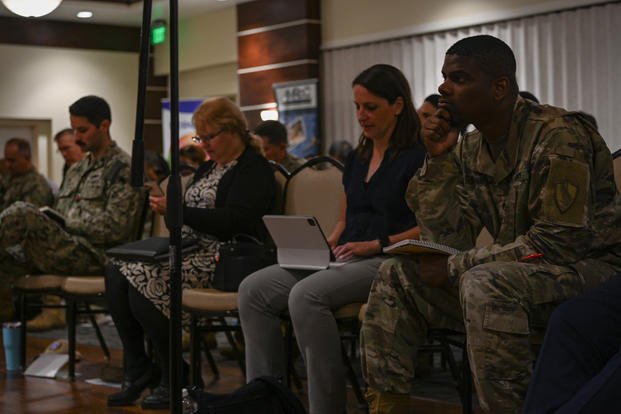 An airman speaks to panelists at an entrepreneurial workshop at MacDill Air Force Base, Florida.