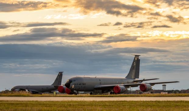 Two U.S. Air Force KC-135 Stratotanker aircraft assigned to the 100th Air Refueling Wing sit side-by-side during sunset on Royal Air Force Mildenhall, England, June 30, 2022.