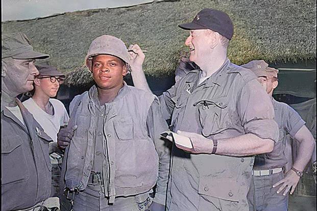 John Wayne signs the helmet of Private 1st Class Fonzell Wofford during a visit at Chu Lai, South Vietnam, in June 1966. (Wikimedia Commons) John Wayne signs the helmet of Private 1st Class Fonzell Wofford during a visit at Chu Lai, South Vietnam, in June 1966.