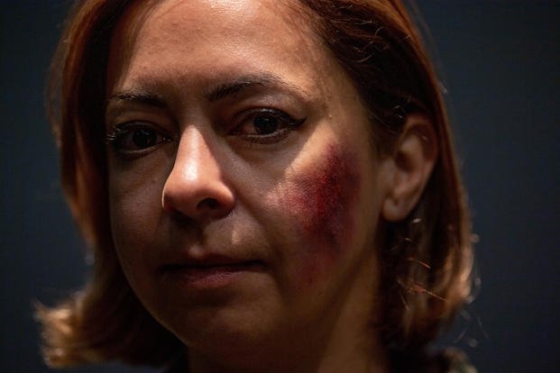 U.S. Air Force Senior Master Sgt. Iris Sanabria showcases her makeup for the Black Eye Project at Ramstein Air Base, Germany, Oct. 26, 2022. Sanabria was one of six volunteers in the Black Eye Project, a social experiment to assess public reactions to signs of abuse as part of Domestic Violence Awareness Month. (U.S. Air Force photo by Airman 1st Class Jordan Lazaro) Black Eye Project at Ramstein Air Base, Germany
