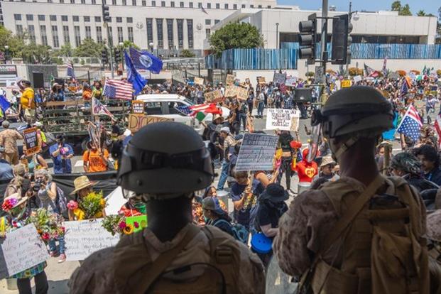 U.S. Marines with 3rd Battalion, 7th Marine Regiment, 1st Marine Division, attached to Task Force 51, guard a federal area in Los Angeles, July 4, 2025. U.S. Northern Command is supporting federal agencies by providing military forces to protect federal functions, personnel, and property in the greater Los Angeles area. On June 7, the Secretary of Defense directed USNORTHCOM to establish Task Force 51 to oversee Title 10 forces supporting this mission. (U.S. Marine Corps photo by Cpl. Jaye Townsend).