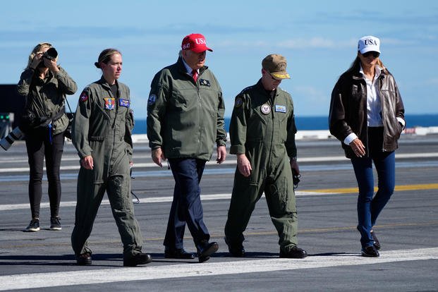 President Donald Trump and first lady Melania Trump walk on the flight deck as part of the Navy's 250th anniversary celebration, aboard the USS George H.W. Bush aircraft carrier in the Atlantic Ocean off the coast of Norfolk, Va., Sunday, Oct. 5, 2025. (AP Photo/Alex Brandon) Trump Navy