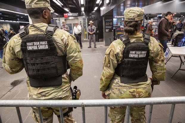 Troops Maintain Security Watch Across New York  Members of the Armed Forces, including the National Guard, patrol the subway system in Penn Station as police officers check commuters' bags in New York on Thursday, March 7, 2024. (AP Photo/Ted Shaffrey)