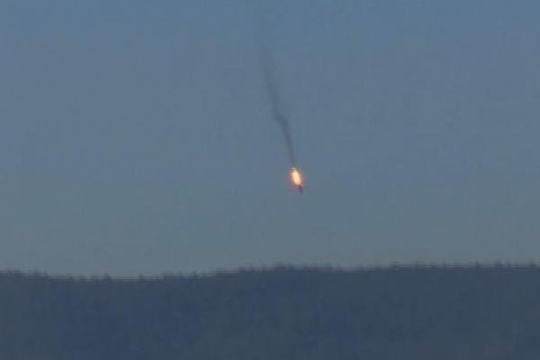 This frame grab from video by Haberturk TV, shows a Russian warplane on fire before crashing on a hill as seen from Hatay province, Turkey, Nov. 24, 2015. Turkey shot down the Russian warplane, claiming it had violated Turkish airspace. (Haberturk TV)