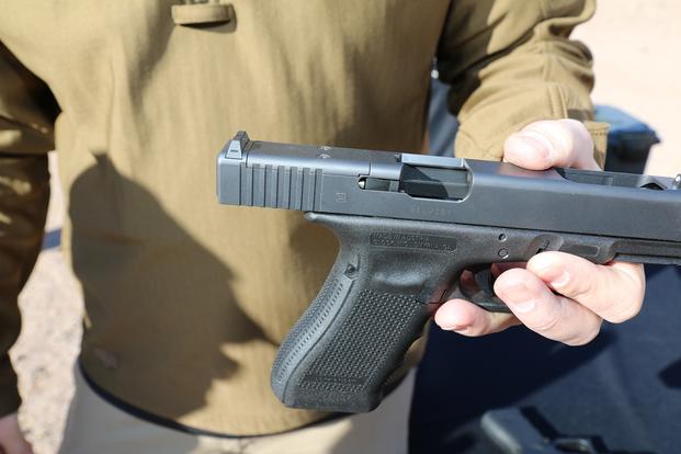 Kyle Hopp, commercial manager for Glock, shows off the company's new Modular Optic System, or MOS, Jan. 18, 2016, at SHOT Show's range day outside Las Vegas. (Photo by Brendan McGarry/Military.com)