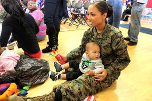 A Marine sitting with her baby son.