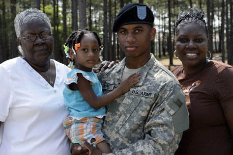 Soldier with family in woods.