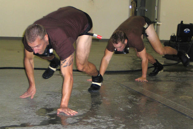 Candidates for the combat rescue officer selection program train for the water confidence portion with a bear crawl. 