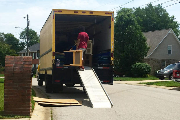 PCS movers putting a small table on a truck
